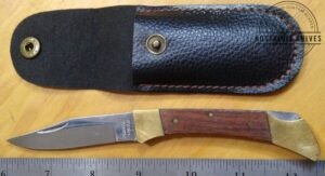 Folding knife with locking clip-point blade, and leather sheath [Used]
